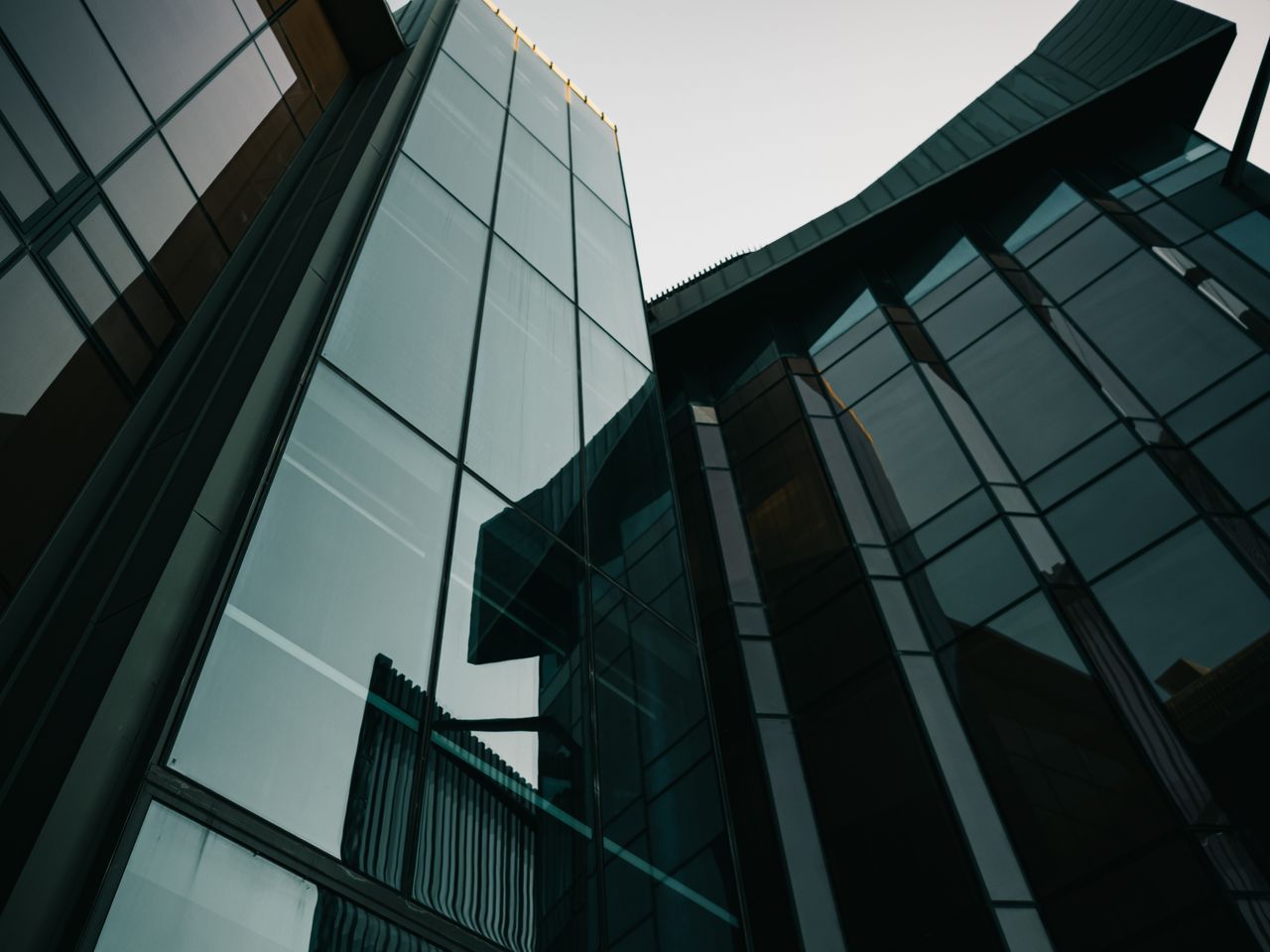 The Art of Drawing Readers In: Your attractive post title goes here A striking view of modern glass building facades in an urban environment, showcasing contemporary architecture.